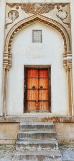 Low angle view of closed door of old building