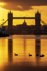 View of bridge over river during sunset