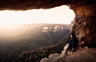 Woman sitting in cave