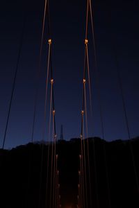 Low angle view of suspension bridge at night