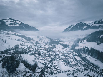 Scenic view of snow covered mountains against sky