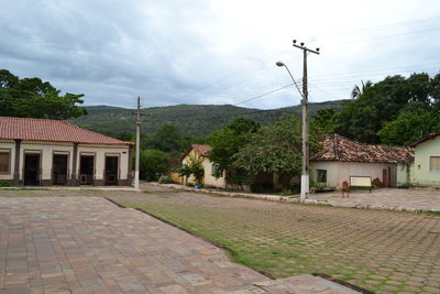 Houses in town against cloudy sky