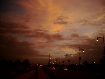 Street light against cloudy sky