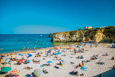 Panoramic view of beach against clear blue sky