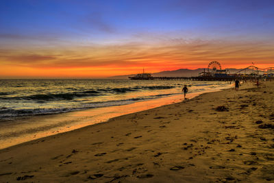 Scenic view of beach against sky during sunset