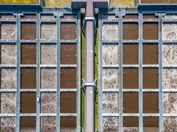 High angle view of walkway over water at factory during sunny day