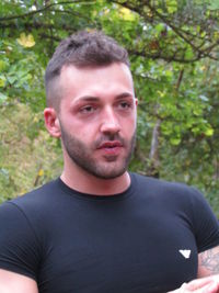 Portrait of young man against trees