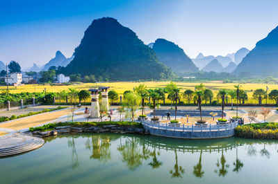 Scenic view of lake and mountains against sky