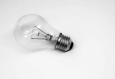 Close-up of light bulb against white background