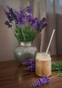 Close-up of purple flower in vase on table