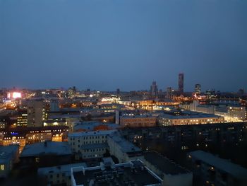 High angle view of illuminated buildings against clear sky at night