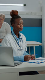 Doctor using laptop at clinic