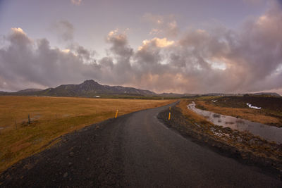 Empty road along countryside landscape