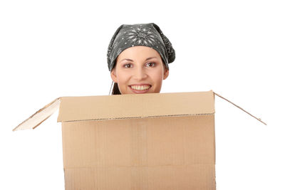 Portrait of smiling young woman against white background