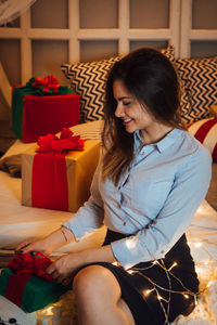 Smiling young woman sitting in box