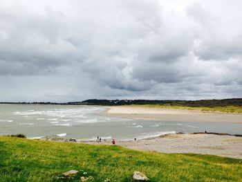 Scenic view of sea against cloudy sky