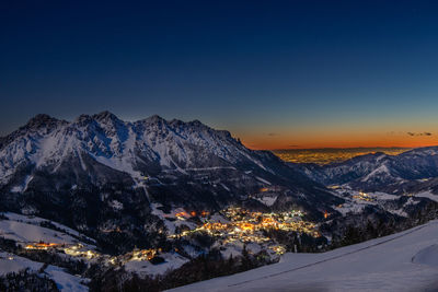 Scenic view of snowcapped mountains against sky during sunset