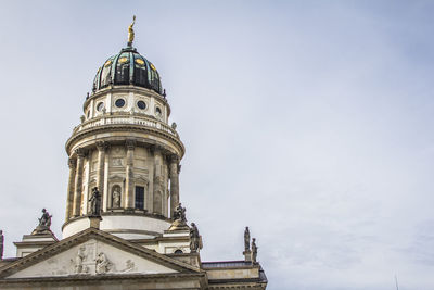 Low angle view of neue kirche against sky in city