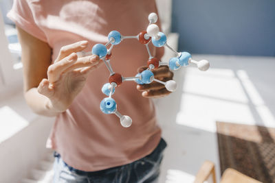 Female scientist holding molecule model