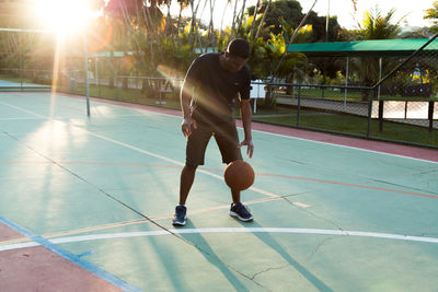 Full length of man playing basketball