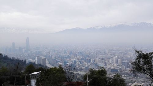 High angle view of city against cloudy sky