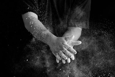 Close-up of human hand against black background