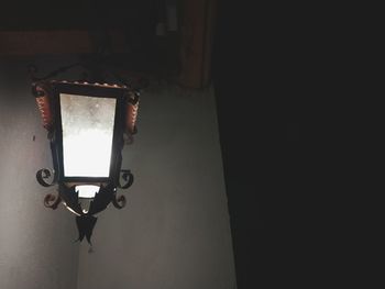 Close-up of electric lamp against wall