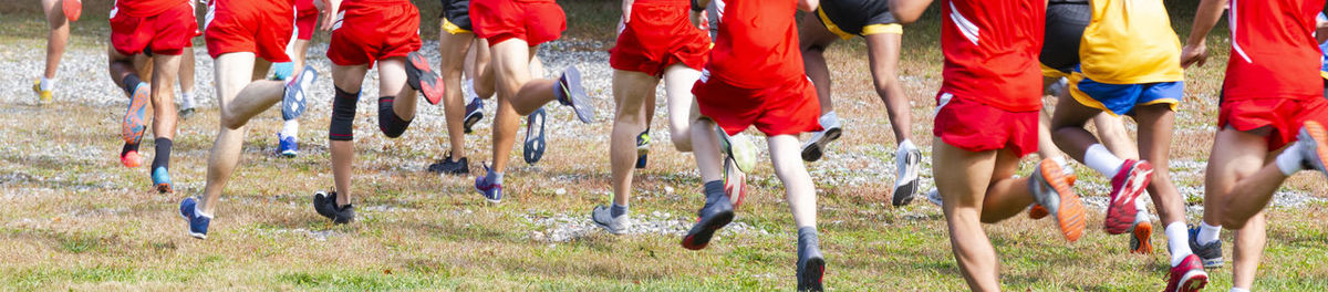 Low section of people running on street