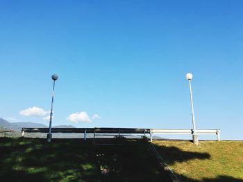 Low angle view of floodlight against clear blue sky