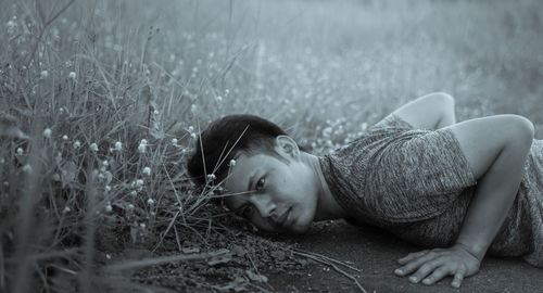 Portrait of man relaxing on field