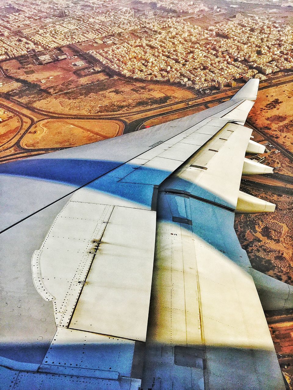 high angle view, aerial view, landscape, transportation, airplane, aircraft wing, sunlight, air vehicle, part of, cropped, flying, day, water, outdoors, sand, nature, beach, shadow, travel, field