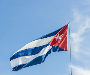 Low angle view of cuban flag against sky