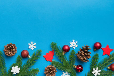 Directly above shot of christmas decorations on blue background