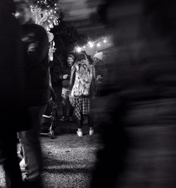 Blurred motion of people walking on illuminated stage