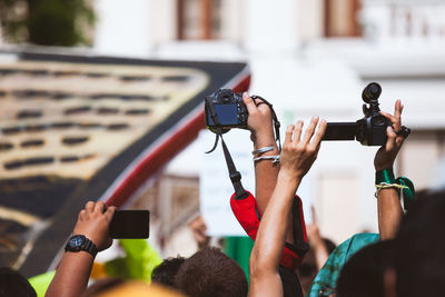 Midsection of woman photographing with mobile phone