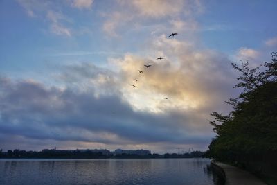 Scenic view of lake against cloudy sky