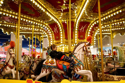 People in amusement park at night