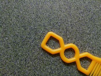 High angle view of yellow toy on land