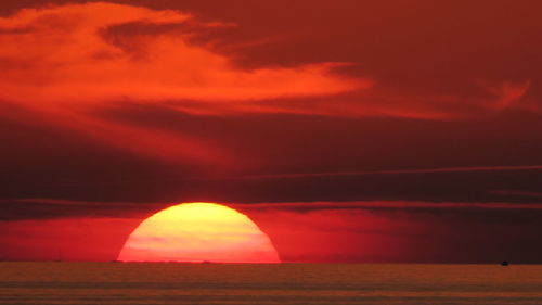 Scenic view of dramatic sky over sea during sunset