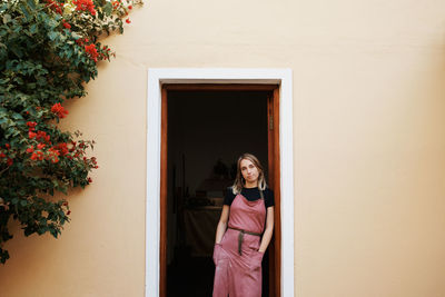 Portrait of woman standing at door