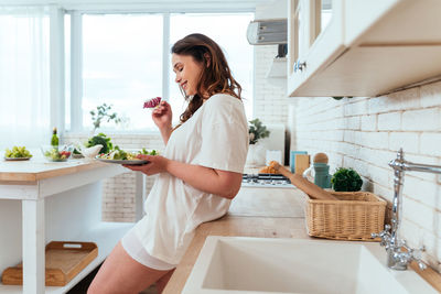 Woman holding ice cream at home