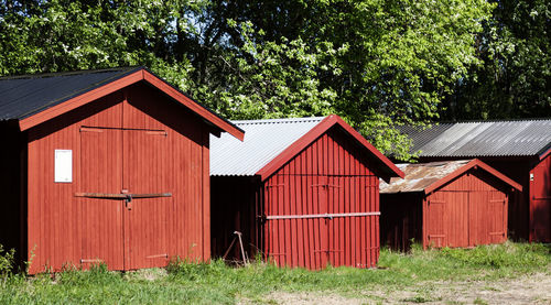 Red boathouses in a row by the river