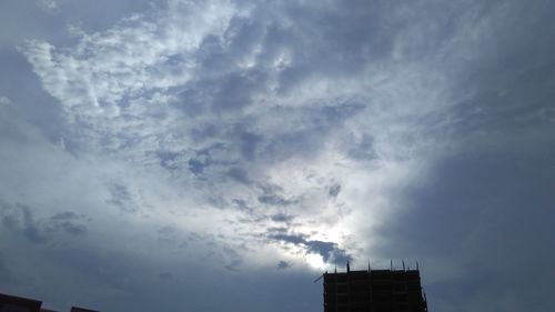 Low angle view of building against cloudy sky