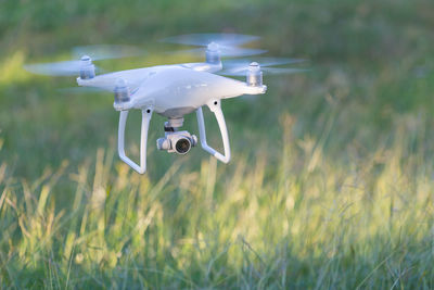 Close-up of drone flying on field