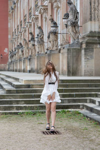 Full length of woman against building