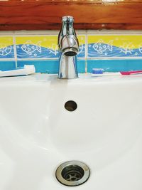 Close-up of faucet in bathroom