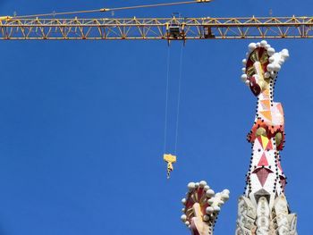 Low angle view of sculpture against clear blue sky