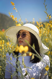 Portrait of woman with yellow flowers