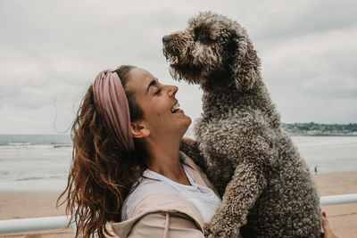 Happy woman with dog at beach