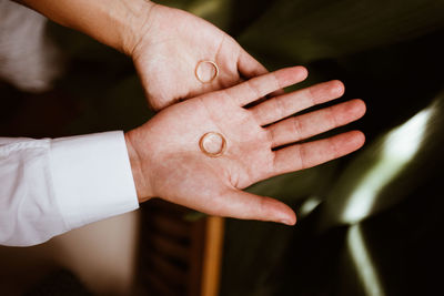 Man and woman with wedding rings in open hands. exchange rings. happy groom and bride